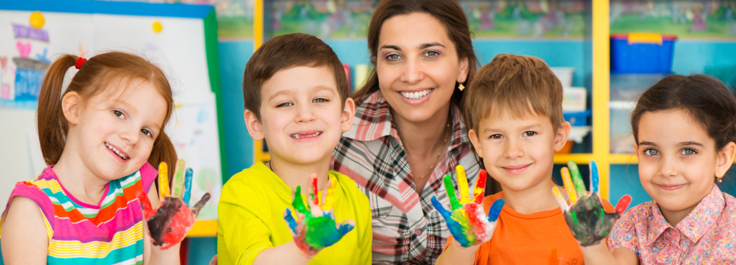 teacher and kids with paint in hand