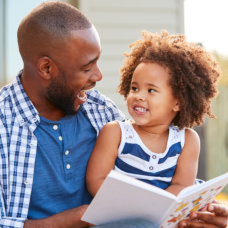 man and a child smiling