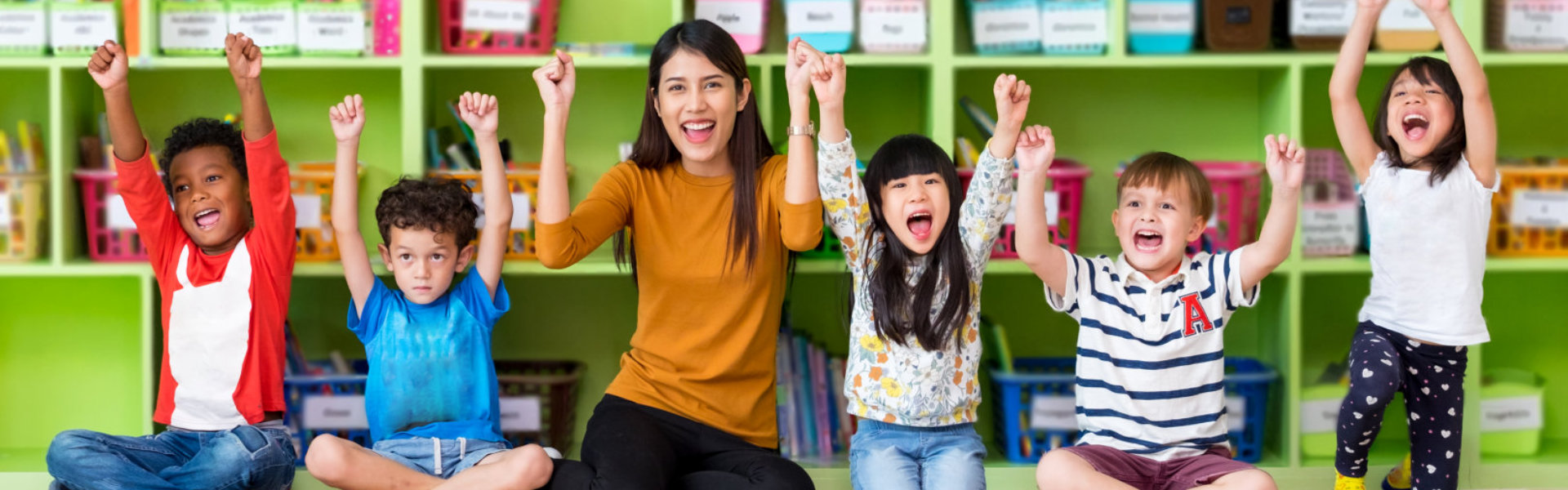 teacher and kids raising their hands