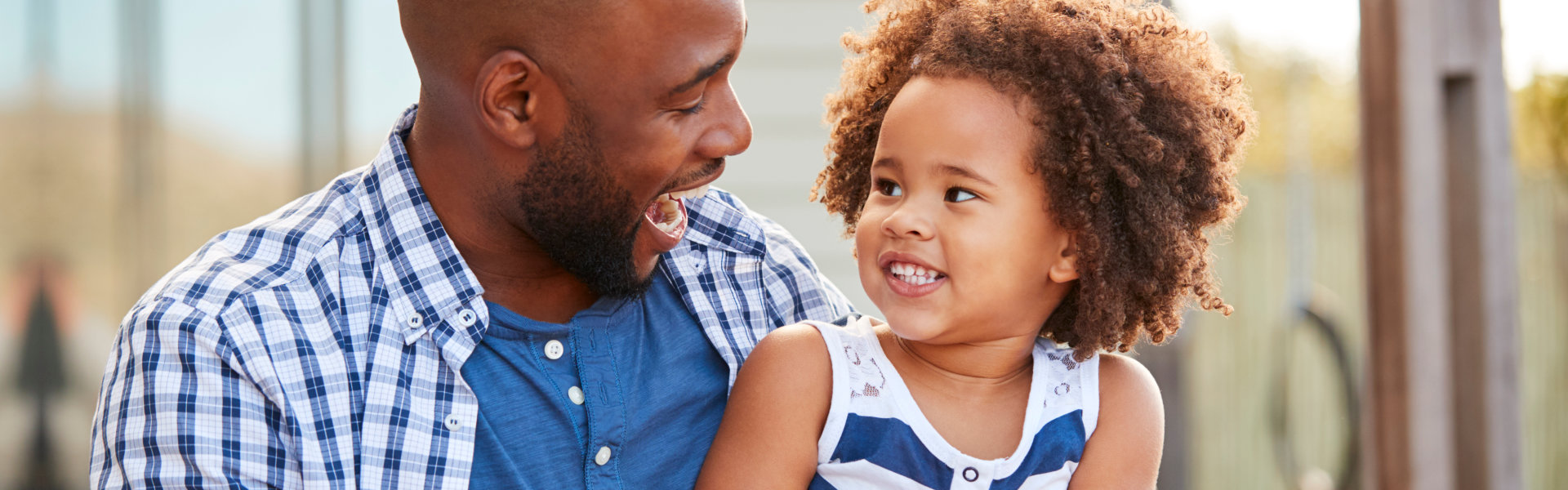 man and a child smiling